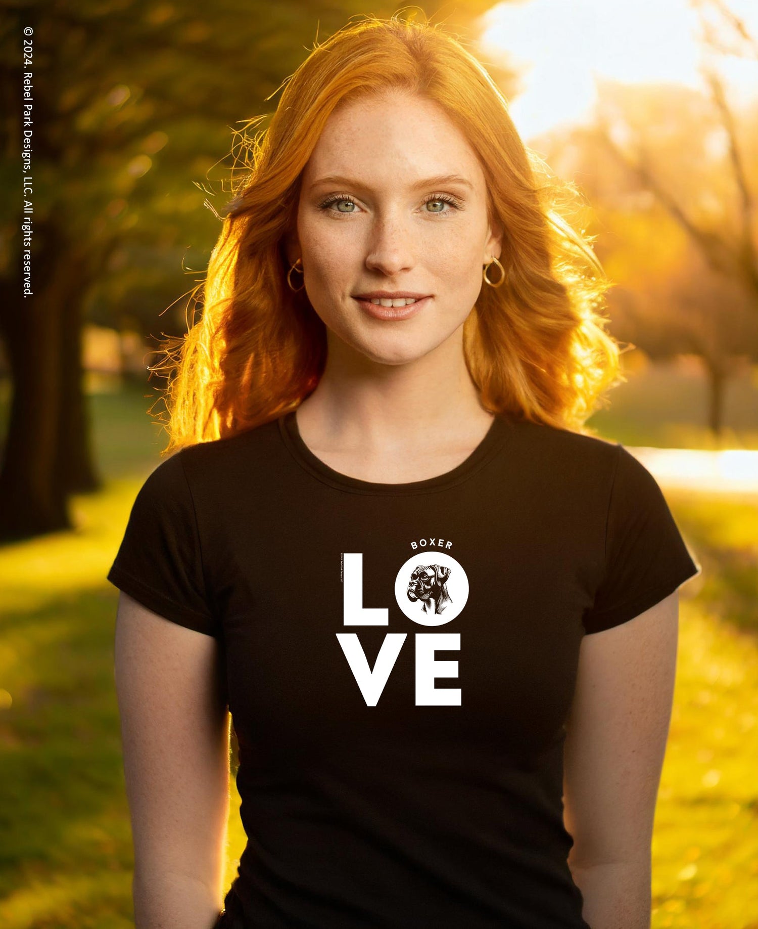 Woman wearing a black t-shirt with 'BOXER LOVE' printed on it in an outdoor setting