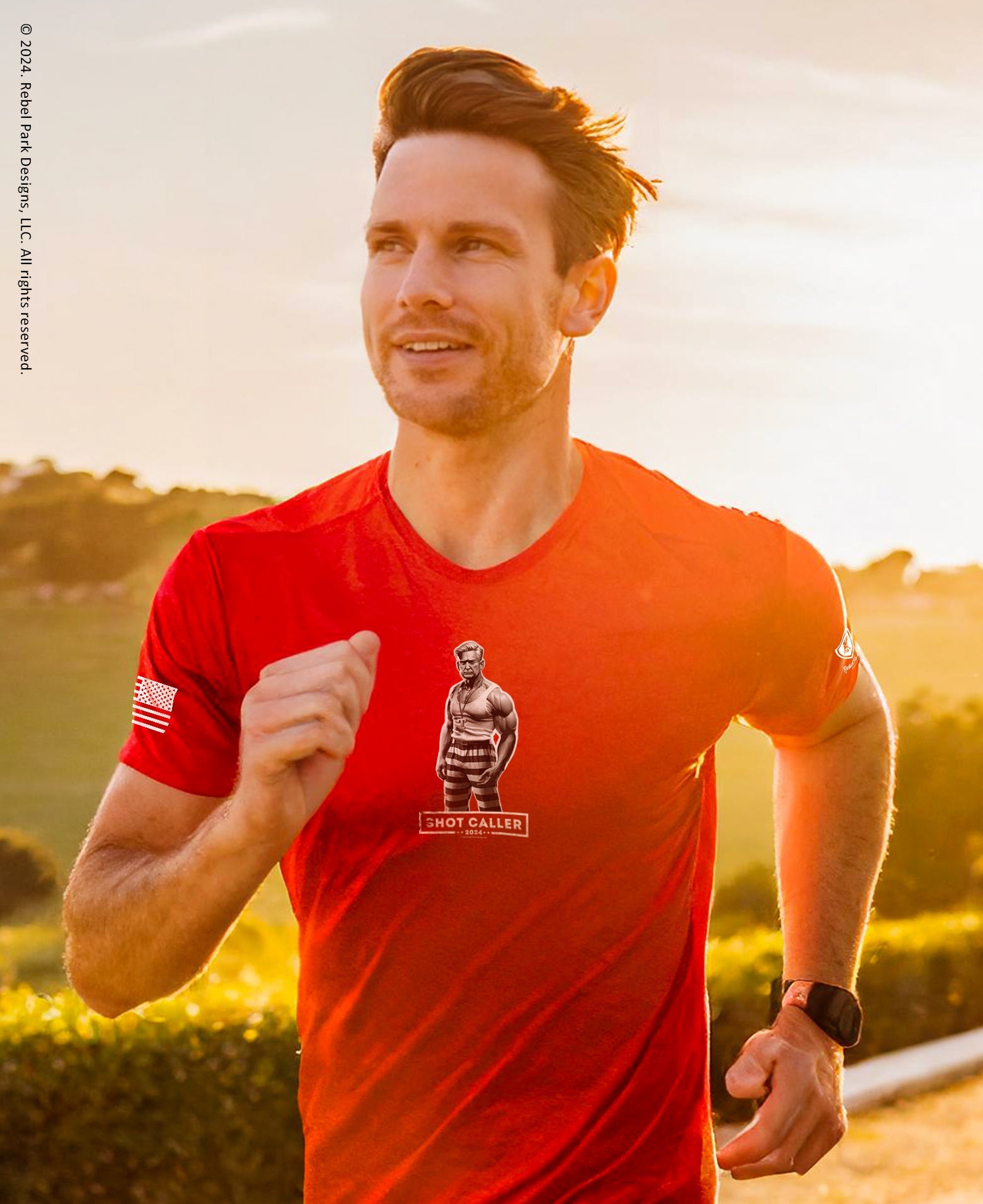 Man running outdoors wearing a red t-shirt with a logo on a sunny day.