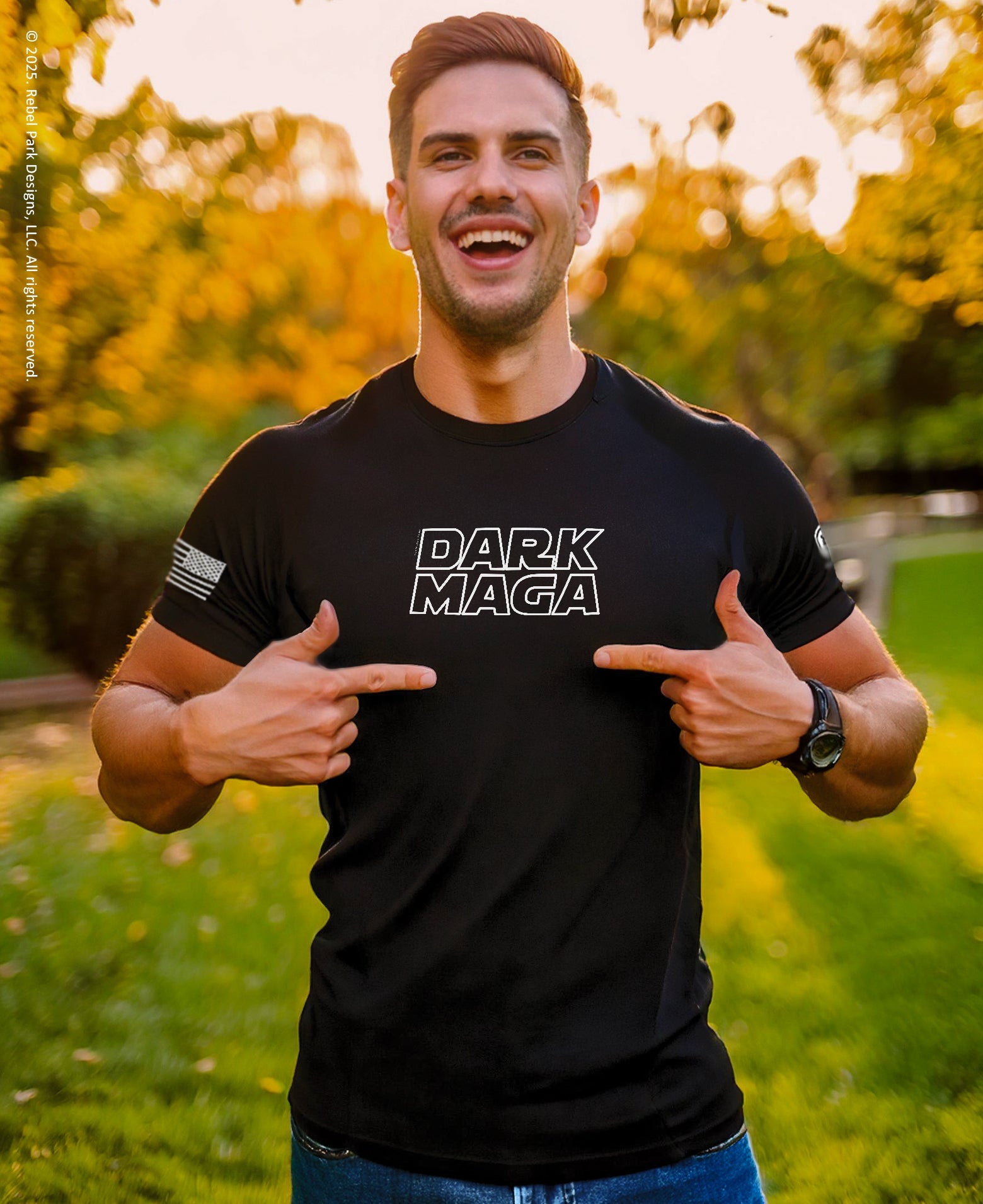 Man wearing a black t-shirt with 'DARK MAGA' text, pointing at it outdoors.
