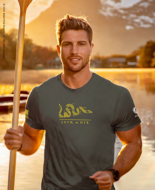 Man holding a paddle with a scenic background