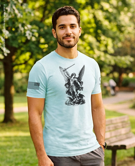 Man wearing a light blue t-shirt with a graphic design in a park