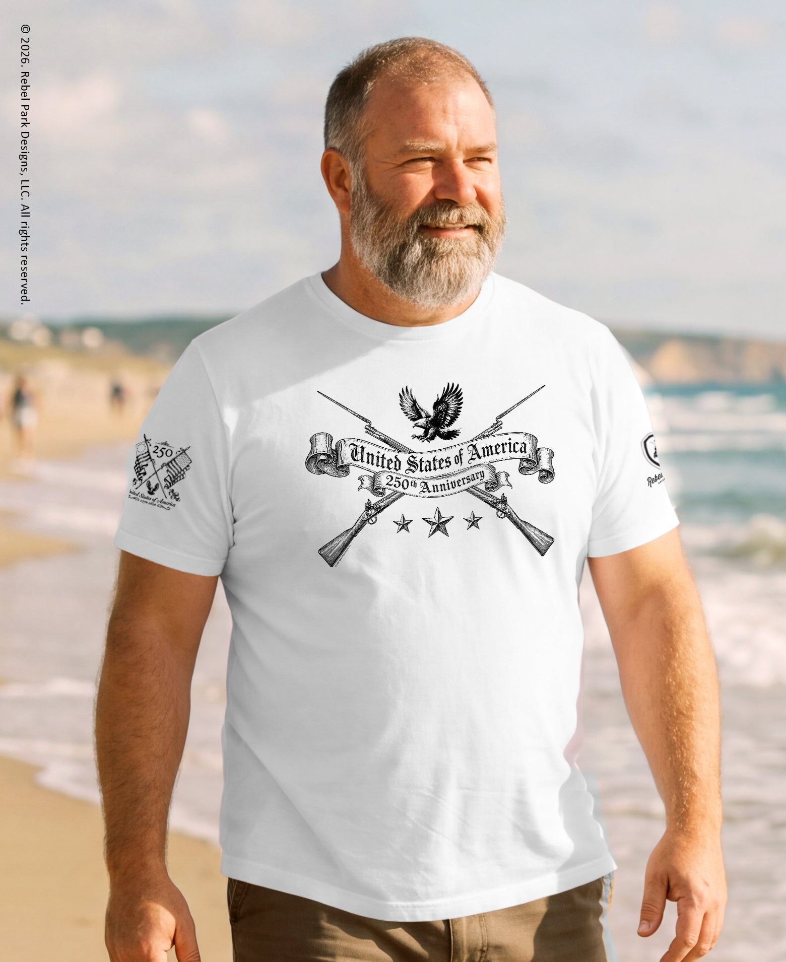 Man wearing a white t-shirt with a graphic design on a beach