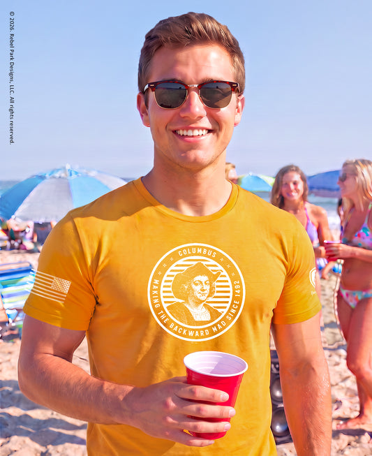 man wearing a columbus t-shirt at the beach.
