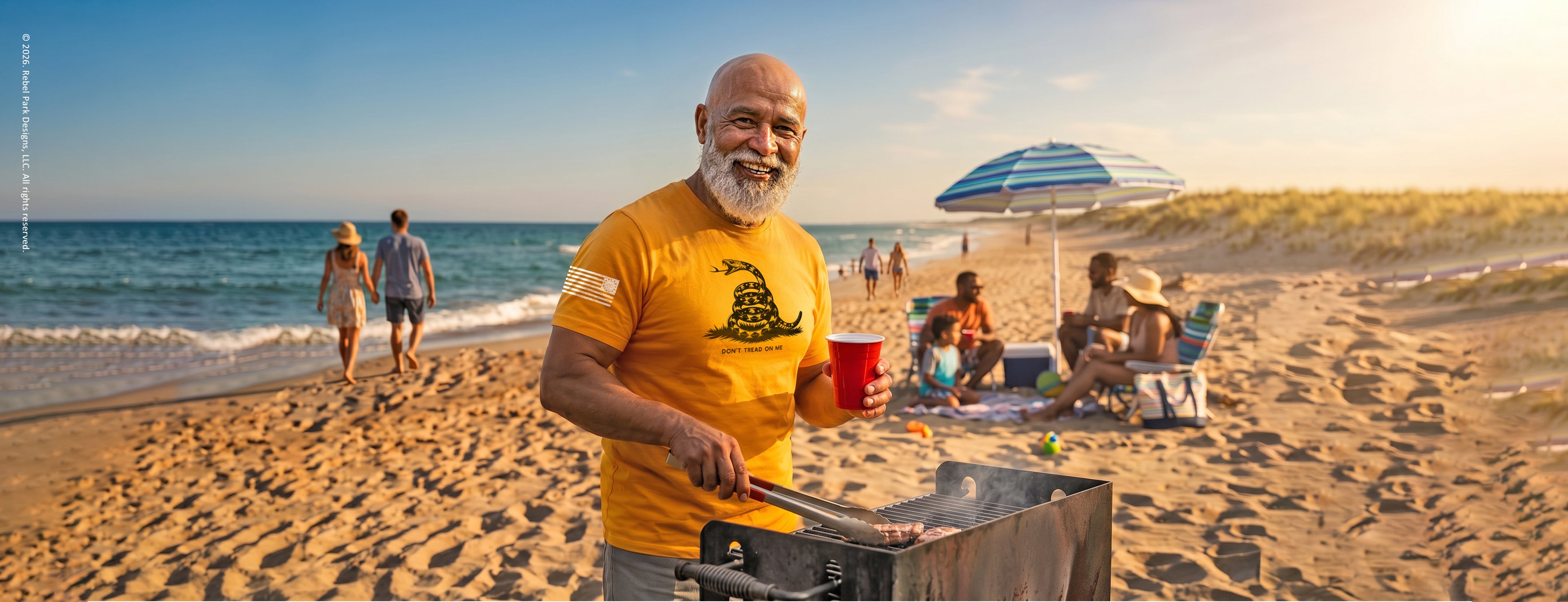 Man grilling on a beach with people and umbrellas in the background