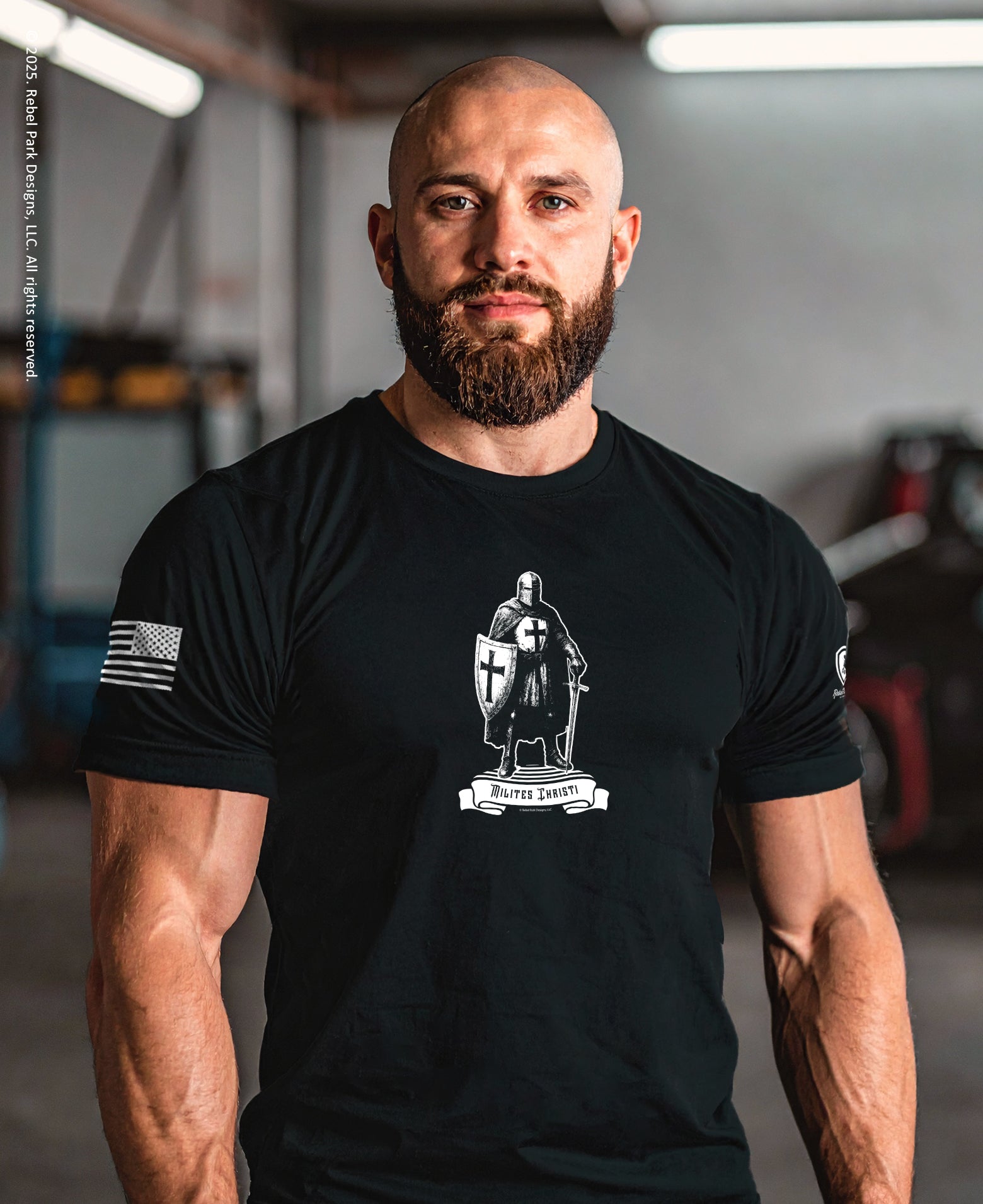 Man wearing a black t-shirt with a graphic design in an indoor setting