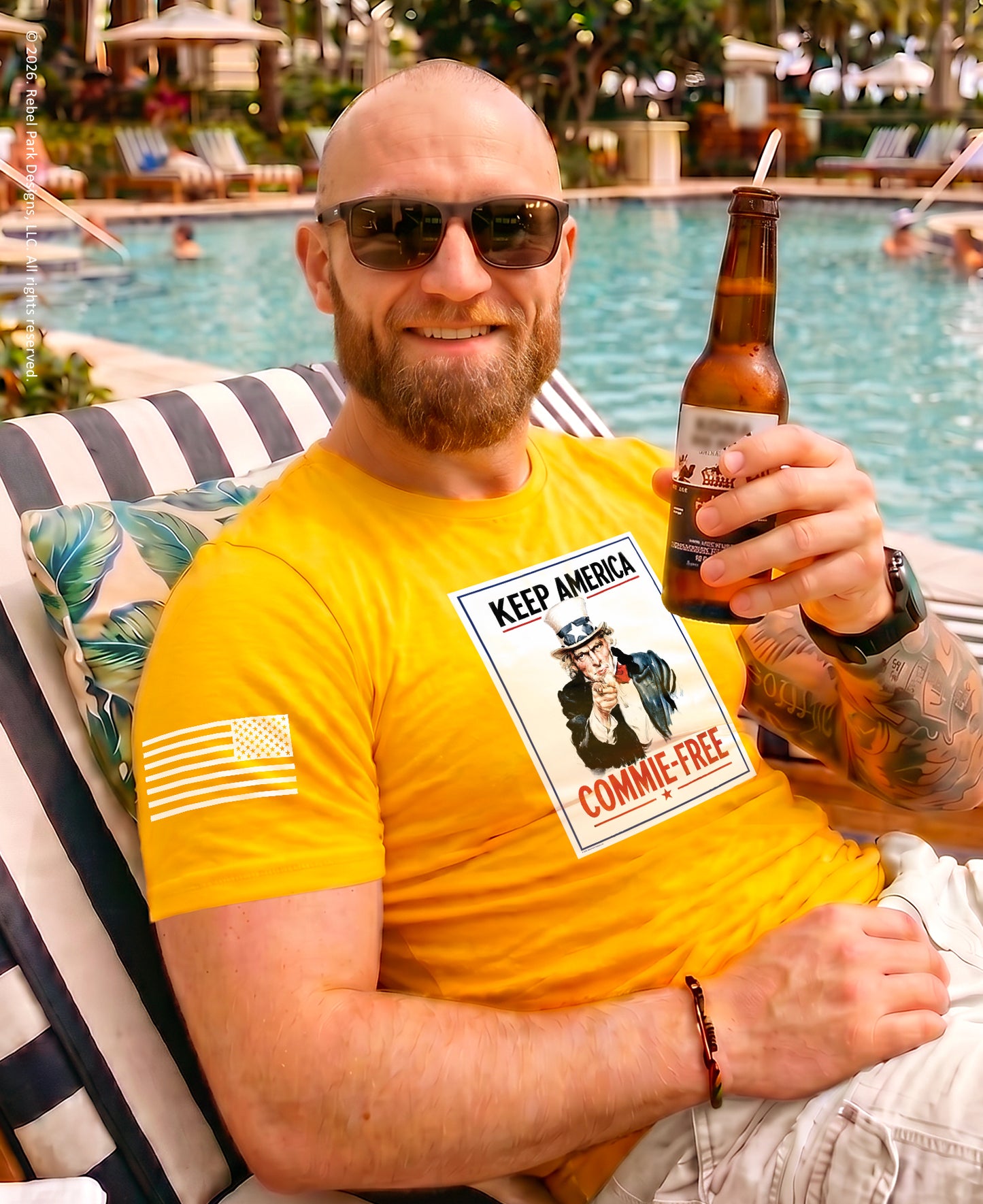 Man holding a drink at pool wearing yellow t-shirt