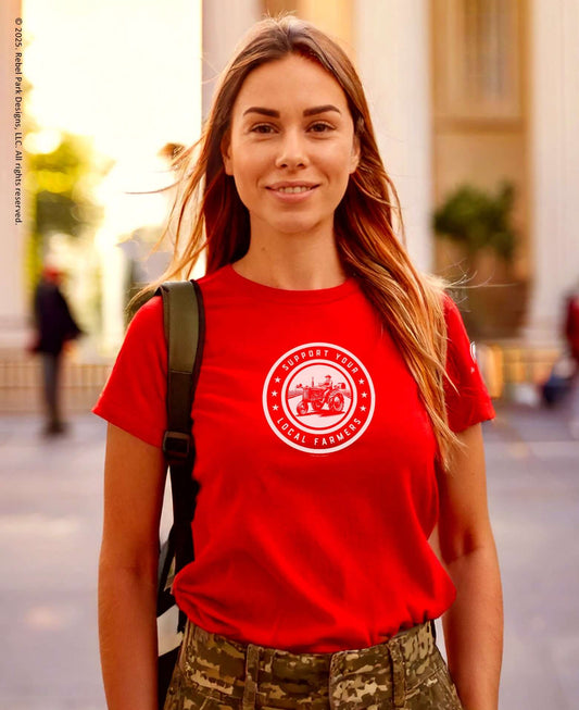 Woman wearing red Support Your Local Farmers t-shirt, promoting rural values and community support.